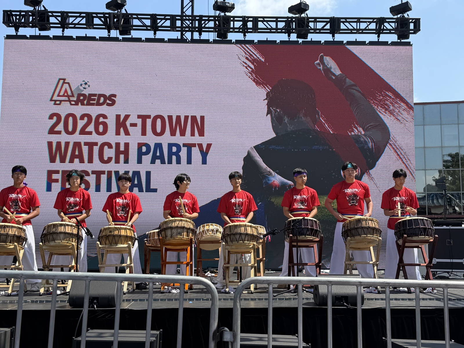 NANTA performers in red uniforms playing Korean drums at the 2026 K-Town Watch Party Festival